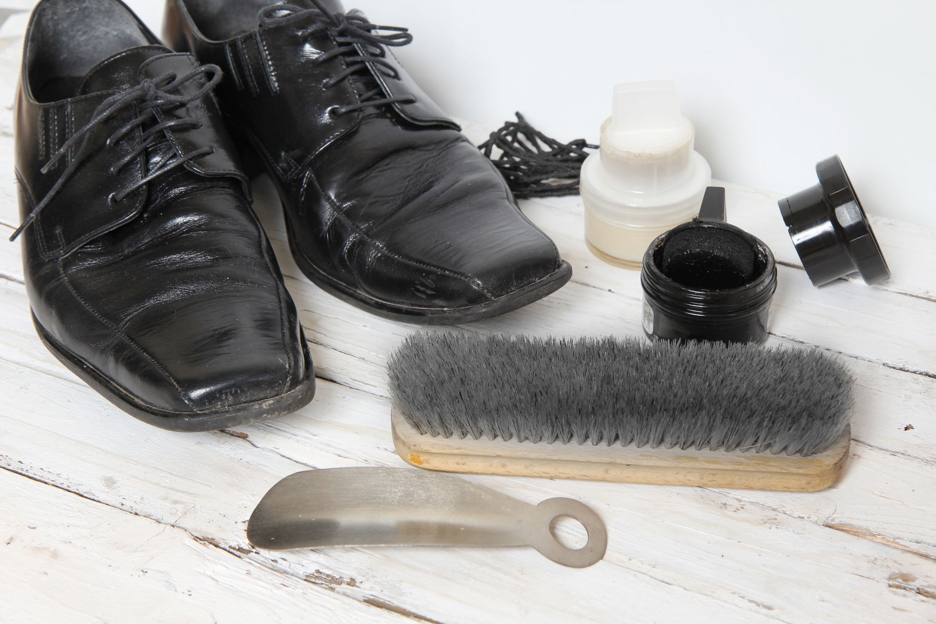 shoe care equipment and formal black shoe on white background shoe care equipment and formal black shoe on white background